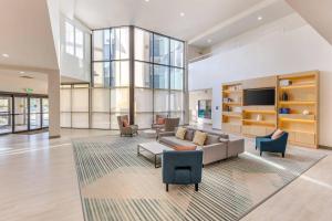 a living room with a couch and chairs and a tv at Comfort Inn & Suites Verona at Turning Stone Resort Casino in Verona
