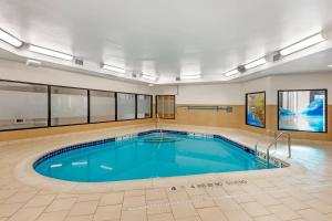 a large swimming pool in a large room with at Comfort Inn & Suites Verona at Turning Stone Resort Casino in Verona