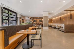 a restaurant with tables and chairs and a bar at Cambria Hotel Portland - Pearl District in Portland