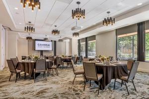 a conference room with tables and chairs and a projection screen at Cambria Hotel Portland - Pearl District in Portland