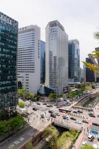 a city with tall buildings and a street with cars at Hotel LETS POP in Seoul