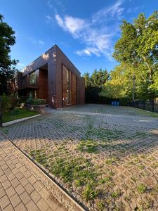 a house with a brick driveway in front of it at BH Kristály in Debrecen