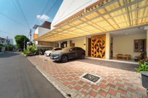 a car parked in front of a building at Tempuran Suites By ARBA in Kejayan