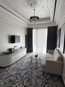 a living room with a couch and a table at Mustafa Hotel in Samarkand