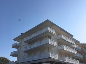 a building with balconies on the side of it at Appartamenti al Cigno in Lignano Sabbiadoro