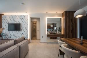 a living room with a couch and a table at Celeste Luxury Villas in Lartos