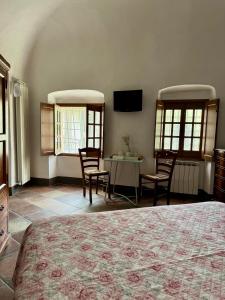 a bedroom with a bed and a table and chairs at Agriturismo Coppi Rossi in Imperia
