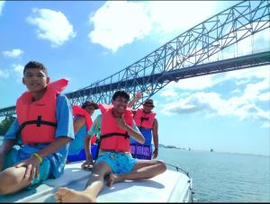 a group of people wearing life jackets on a boat in the water at Tour Full Day Taboga in Panama City