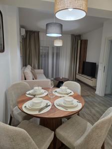 a dining room with a table and chairs and a living room at A&A Apartment in Šušanj +3 photos