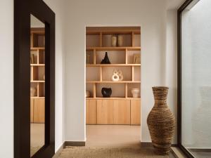 a hallway with a vase in a room at PanoPlagia Villa in Agios Nikolaos