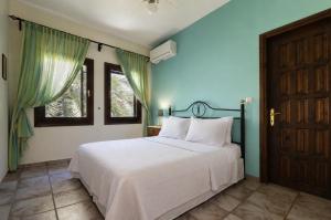 a bedroom with a white bed and a window at Thalia- 2 Bedroom Beachfront Apartment! in Lefokastro +33 photos