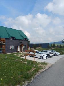 a group of cars parked in front of a house at Vila Danida in Žabljak