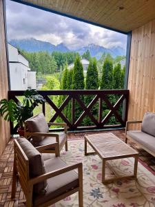 a screened in porch with a view of the mountains at Villa Montis in Vysoké Tatry