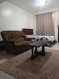 a living room with a couch and a coffee table at Limuru stays in Ngecha