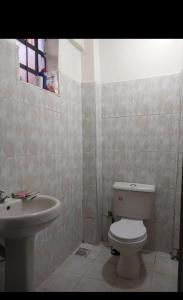 a bathroom with a toilet and a sink at Limuru stays in Ngecha