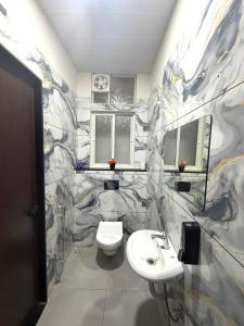 a bathroom with a toilet and a sink at Yatha sukham Prutham in Ujjain