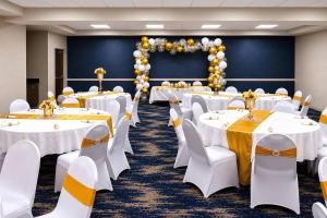 a banquet room with white tables and balloons at Comfort Suites Palm Bay - Melbourne in Palm Bay