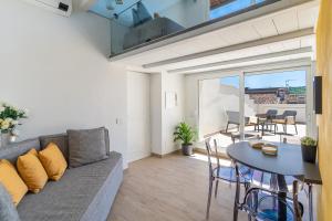 a living room with a couch and a table at Aromi Piccolo Hotel in Salò