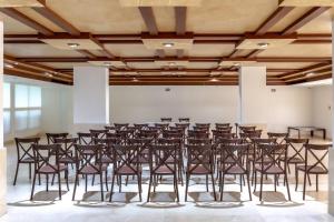 a large room with a bunch of chairs in it at Quality Inn Mazatlan in Mazatlán +57 photos