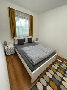 a large bed in a bedroom with a window at Gellénia in Balatonberény