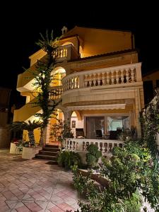 a large building with a staircase in front of it at Apartments Visnja in Vodice
