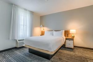 a bedroom with a large white bed and a window at MainStay Suites in Mobile +56 photos