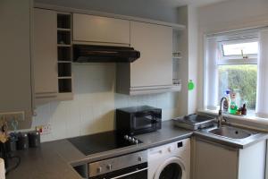 a kitchen with a sink and a microwave at wyvis stays in Inverness