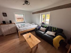 a living room with a couch and a bed at FEWO in Spielberg in Sachsenheim