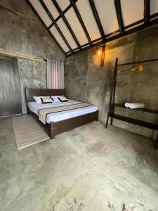 a bedroom with a bed in a room at Aji fruit farm cottage peaceful lakeside farm stay with sunrise views 01 in Embilipitiya
