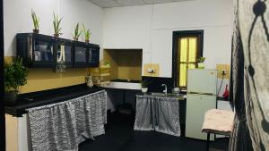 a kitchen with a sink and a refrigerator at JA Villa in Pottuvil +4 photos