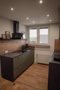 a kitchen with a stove and a counter top at Apartment Claussen 1 in Bremerhaven