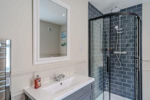 a bathroom with a sink and a shower at Beachcomber, Dog-Friendly Coastal Cottage Close to the Beach in Winterton-on-Sea +13 photos