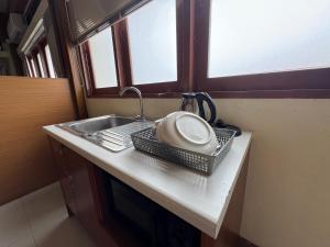 a kitchen counter with a sink and a plate on it at Sukstay Hotel in Bangkok