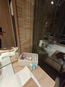 a bathroom with a sink and a box on a counter at Tkalča Room 22 in Zagreb