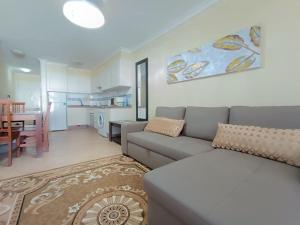 a living room with a couch and a dining room at Apartmán Centrum in Los Cristianos