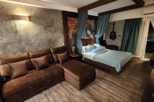 a hotel room with a bed and a couch at Resort-Style 1BR-Epic Pool View-Walk to Beach in Bophut