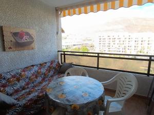a living room with a couch and a table and chairs at Apartmán Centrum in Los Cristianos
