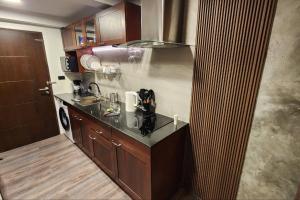 a kitchen with a sink and a counter top at Resort-Style 1BR-Epic Pool View-Walk to Beach in Bophut