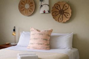 a bedroom with a bed with a pillow on it at Grandview Holiday Beach House in Gracetown