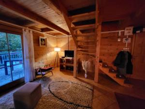 a living room with a couch and a desk in a cabin at Brvnara Pliva 20m jezero rostilj Relax in Nature in Jajce