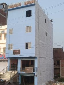 a white building with signs on the side of it at HOTEL अtithi in Rājgīr