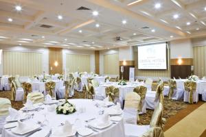 a banquet hall with white tables and chairs and a screen at Crystal Family Comfort Collection - Ultimate All Inclusive in Belek +104 photos