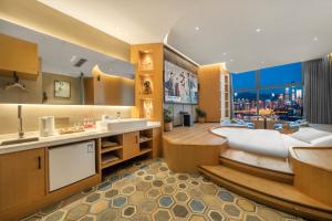 a large bathroom with a tub and a sink at ChongQing BackHome Riverview Hotel in Chongqing