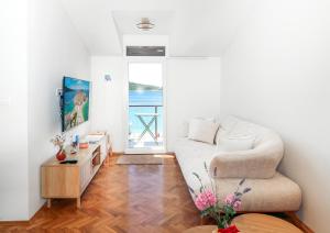 a living room with a couch and a table at D&J Apartments in Primošten