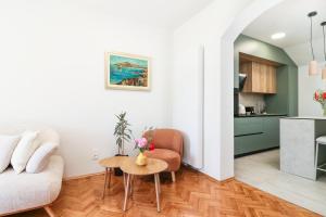 a living room with a couch and a table at D&J Apartments in Primošten