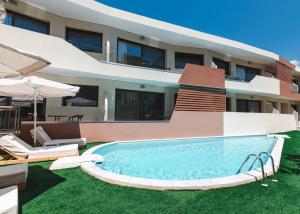 a house with a swimming pool in front of a house at The Wave in Limenaria