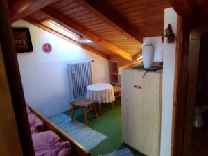 a small room with a table and a refrigerator at Pension Unterleiten in Ramsau