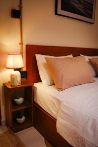 a bedroom with a bed and a night stand with a lamp at Mi Casa Coastal Villa in Akurala