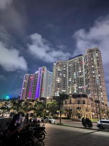 a group of tall buildings in a city at night at Sapphire Premium Studio Hạ Long in Ha Long