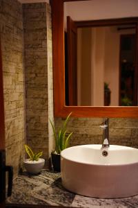 a white sink in a bathroom with a mirror at Mi Casa Coastal Villa in Akurala